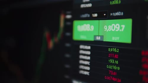 Stock Market Data Scrolling on Dark Computer Screen