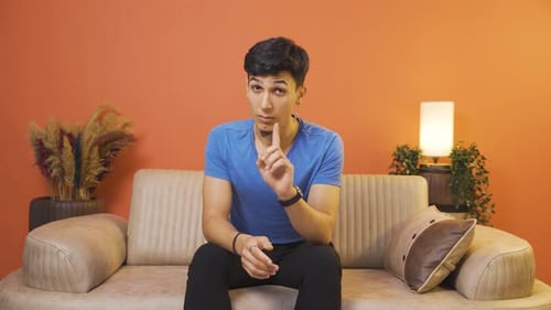 The man is warning by looking at the camera.