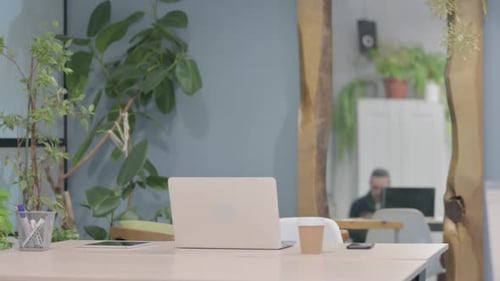 Man Arrives to Work at an Office Desk