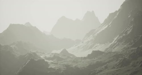 Majestic Mountain Range Under Soft Light Creates Serene Atmosphere in Nature