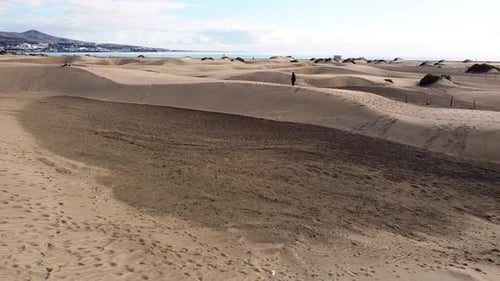 Sand dunes desert against seascape in Maspalomas Gran Canaria deserts near seashore. Aerial drone vi