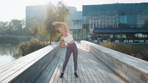 Fit Young Woman Runner Stretching Body Warm Up Before Workout Preparing for Outdoor Jog in City Park