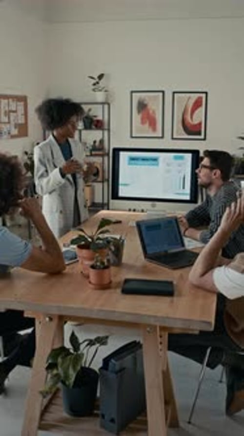 Colleagues Attending Business Meeting, Listening to Presentation in Office