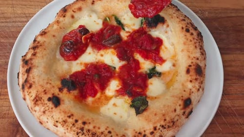 Adding Delicious Tomato Sauce to a Margherita Pizza