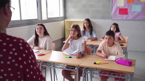 High School Teacher Explaining Lesson to Students in Classroom