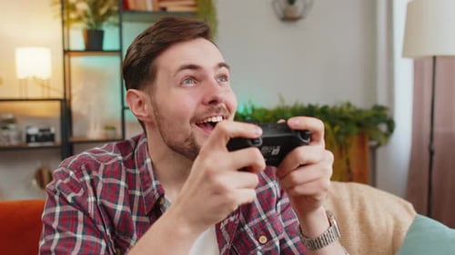 Excited Man Plays Video Game and Wins Indoors