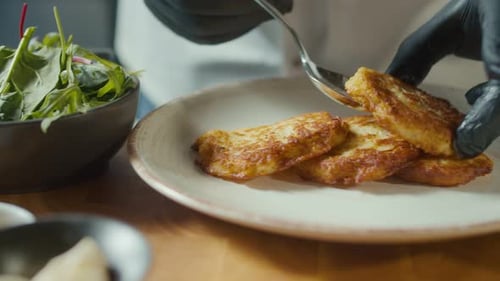Chef Plates Crispy Potato Pancakes with Greens