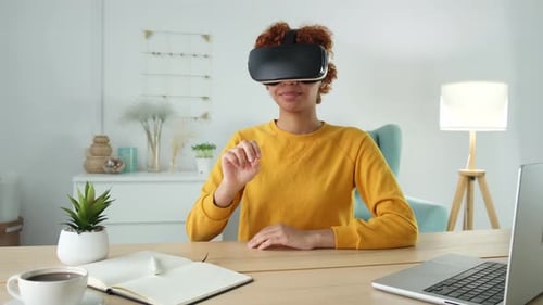 Woman Using Virtual Reality Headset at Desk