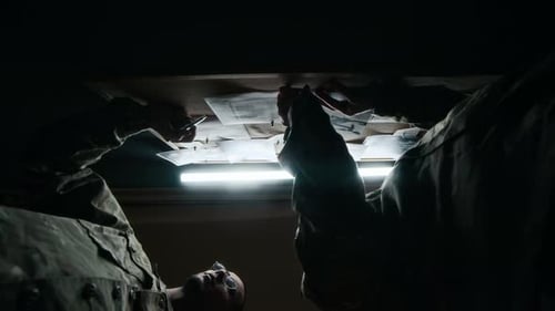 Low Key of Commanders Discussing Military Plan by Board in Command Center