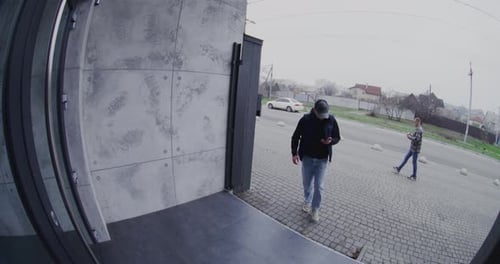 Adult Man Approaches Entrance Door and Unlocks Smart Lock Contactless Using Smartphone
