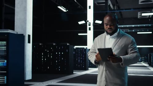 Admin in Data Center Using Tablet to Develop Disaster Recovery Plans