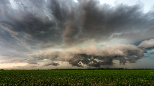 Dramatic Sky Over a Green Field on Overcast Day