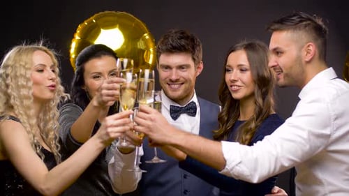 Friends Celebrate with Champagne and Balloons at Party