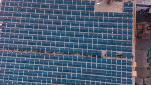 Solar Panels Installed On Roof. Top down view of large area solar photovoltaic panels on rooftop