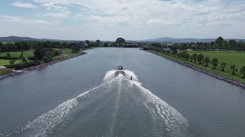 Aerial view of a wakeboarding sport boat practice on the lake with calm water