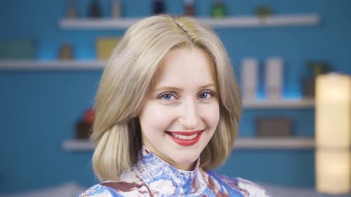 Smiling Woman in Colorful Shirt Posing Indoors
