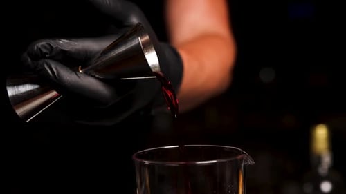 the bartender prepares a cocktail at the bar