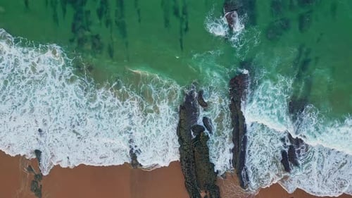 Drohnensurfen am rollenden Strand im Sommer, Luftbild mit türkisfarbenen Meereswellen