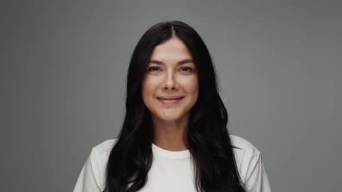 Portrait of Young Woman As Studio Model Looking at Camera and Smiling Happy