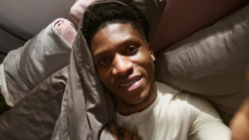 Man Smiling in Bed Close Up Portrait