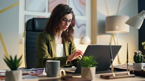 Attractive Manager Focused Laptop Writing Report at Office Workplace Close Up