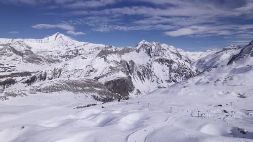Epic Footage of Mountain Range Covered in Snow with Ski Chairlifts - Dolly In Shot - Shot in Tignes