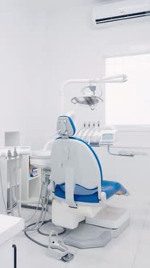 Empty Modern Dentist Chair in a Bright Clinical Office Vertical