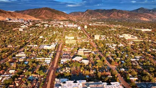 Bright sun of sunset dazzling the dense urban landscape of Salt Lake City, Utah, USA.