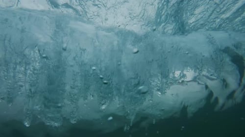 Ocean wave breaks on the shore. Wave rolls and breaks over the coastal area. Underwater camera
