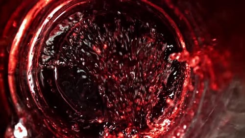 Red Liquid Pouring Inside Glass in Close-Up