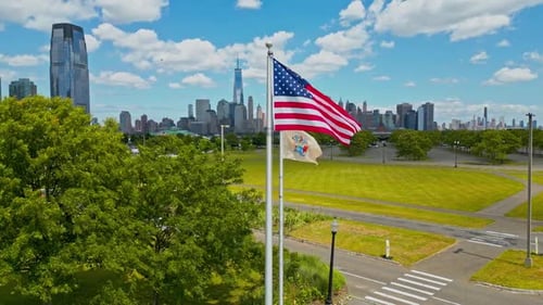 American Flag Waving with City Skyline Backdrop