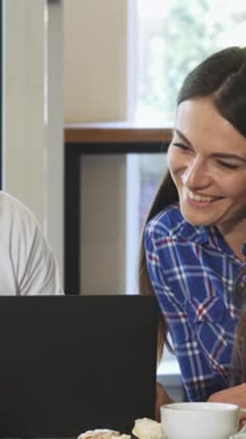 Charming Bearded Man Enjoying Breakfast with Friends at a Cozy Coffee Shop