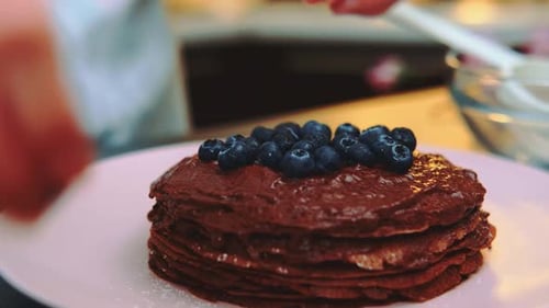 Decorating Chocolate Pancakes with Fresh Blueberries