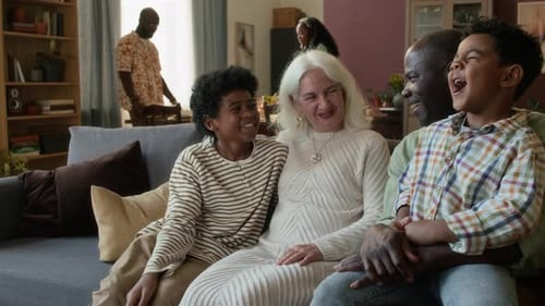 Happy Family Relaxing on Sofa Indoors