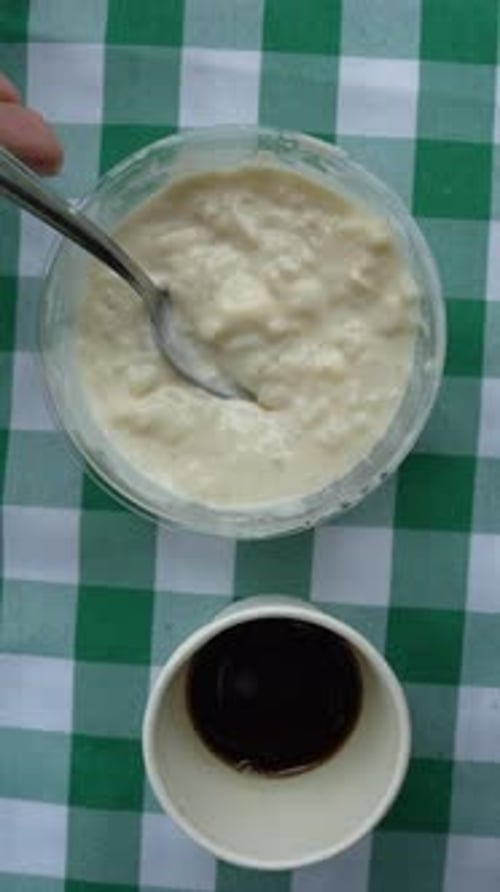 Vertical Close-Up of Arroz con Leche on Checkered Tablecloth