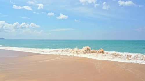 Waves breaking on sandy beach. Slow-motion
