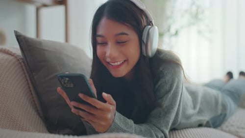 Woman Relaxing with Music and Phone at Home