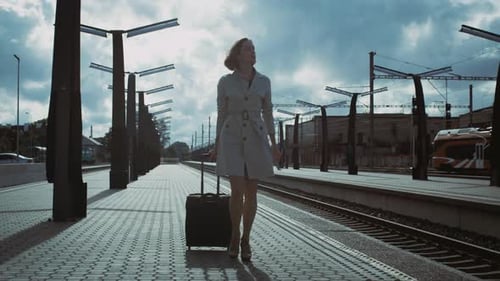 Shot of Woman with Luggage Walking through Railway Station