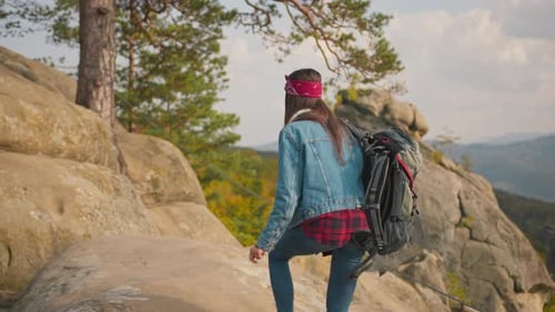 Young Woman Hiking on Rocky Mountain Trail