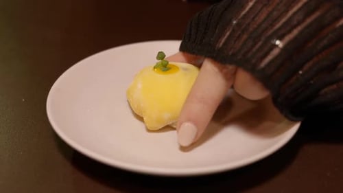 Colourful sticky Mochi confectionary taken from plate in Avant Garde restaurant, Close up