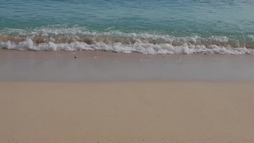 Title Slow Motion Wave Foam Washing Over Pristine Tropical Beach Sand
