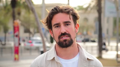 Close Up Individual Portrait of Handsome Bearded Man Looking Serious at Camera with Pensive