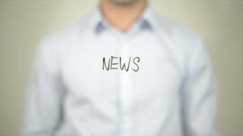 Man Writes News on Transparent Surface