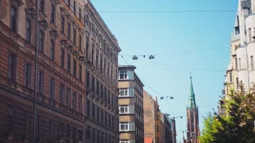A Charming City Street Scene Featuring Historical Architecture Against a Clear and Bright Blue Sky