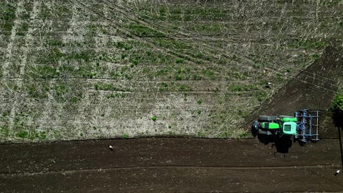 Overhead View Of A Farm Tractor Plow Field. Aerial Shot