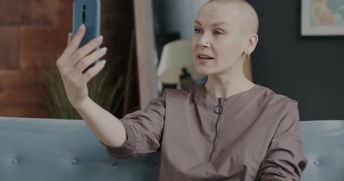 Woman Video Chatting On Smartphone At Home