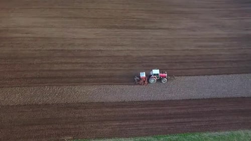 Tractor Plowing Aerial Shot. Drone Footage Of A Tractor Plowing A Field. Countryside Aerial Shot.