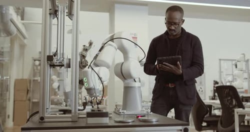 Engineer programming robotic arm
