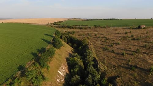 Luftaufnahme von Ackerland in der Ukraine mit einer Straße mit wenig Verkehr bei Sonnenuntergang