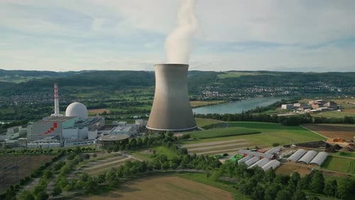 Nuclear power plant with steam rising from stack.Thermal power station with pipe